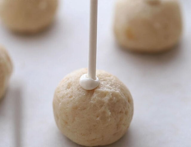 Put sticks into cake balls