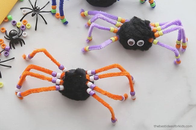 Glue spider legs on spider pom pom