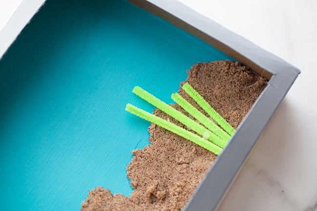 Add Sand and Pipe Cleaners to Aquarium