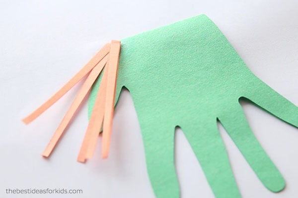 Glue down paper strips for hair