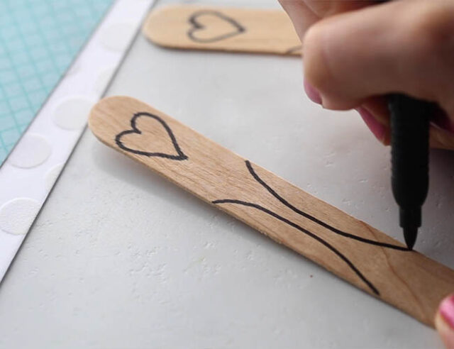 Draw on sides of craft stick
