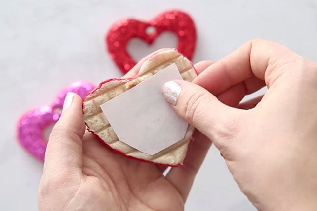 Glue photo to back of heart ornament