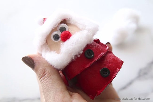 Glue Buttons on Egg Carton Santa