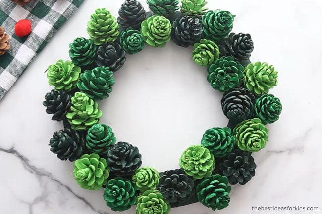 Glue Pine cones to DIY Pine Cone Wreath