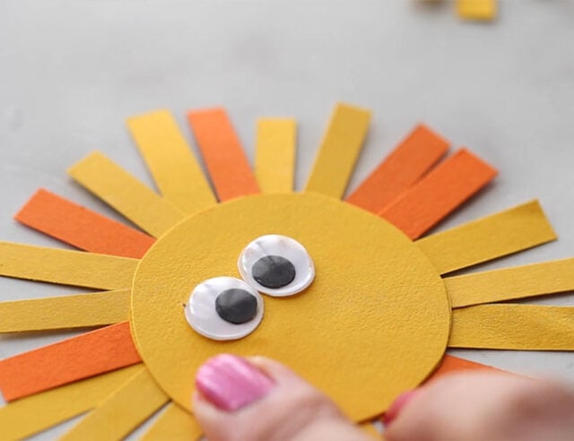 Glue googly eyes to lion head