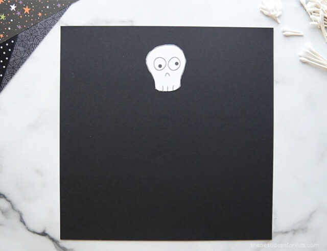 Glue skeleton head to paper