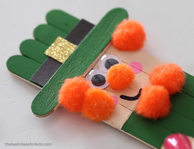 Glue on orange pom poms