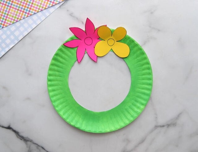 Glue flowers to paper plate