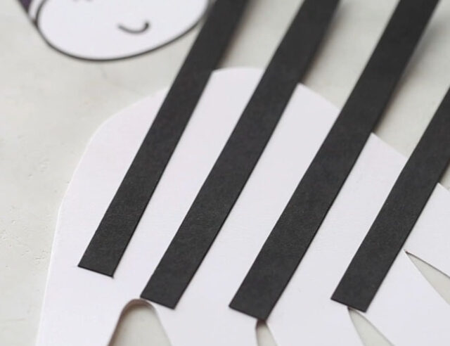 Glue Black Strips to Handprint