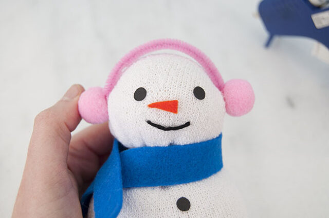 Pom pom earmuffs on snowman