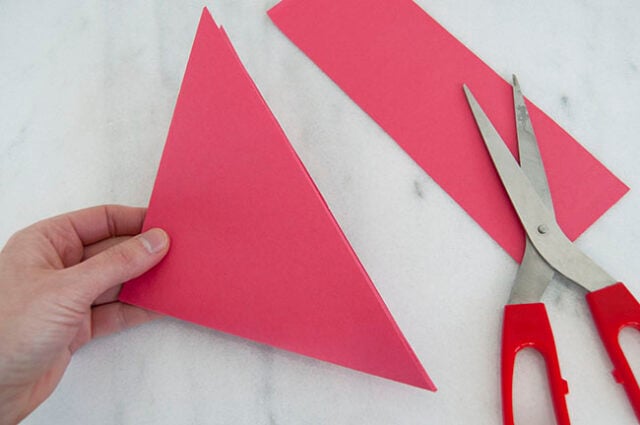 Cutting excess off of red paper