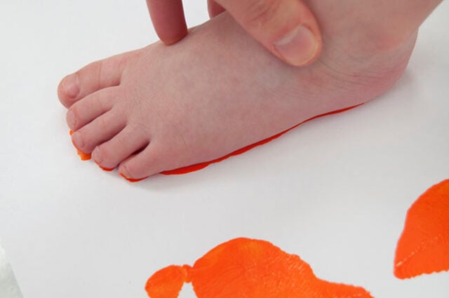 Stamping foot in orange paint