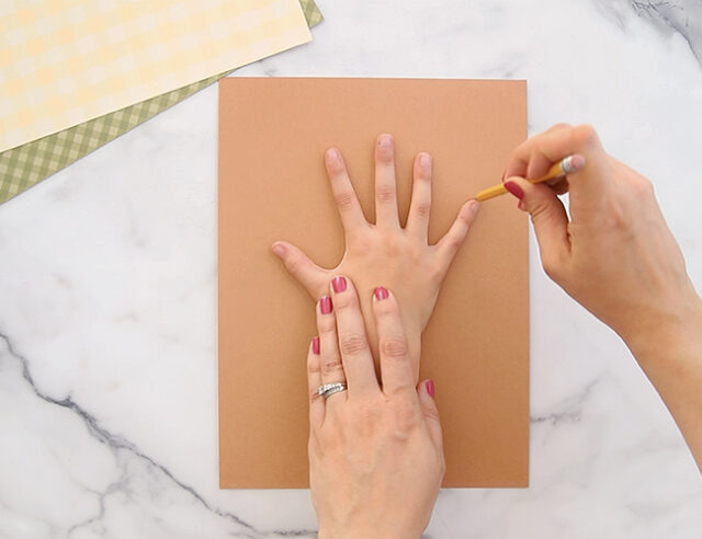 Tracing hand on brown paper