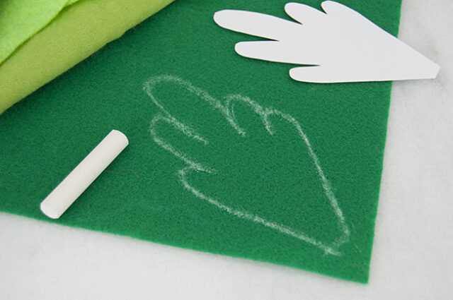 Tracing template onto green felt