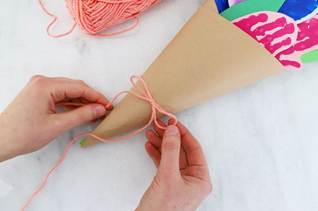 Tying bow onto bouquet