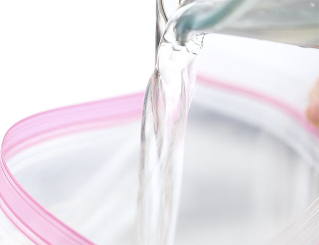 Pouring water into plastic bag