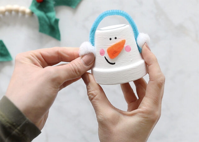 Gluing ear muffs onto pot