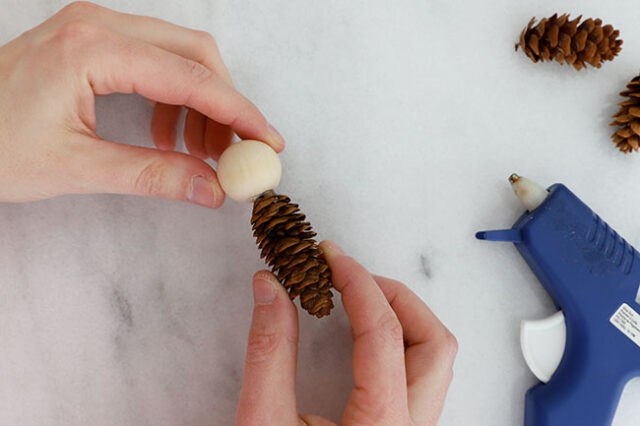 Gluing bead to pine cone