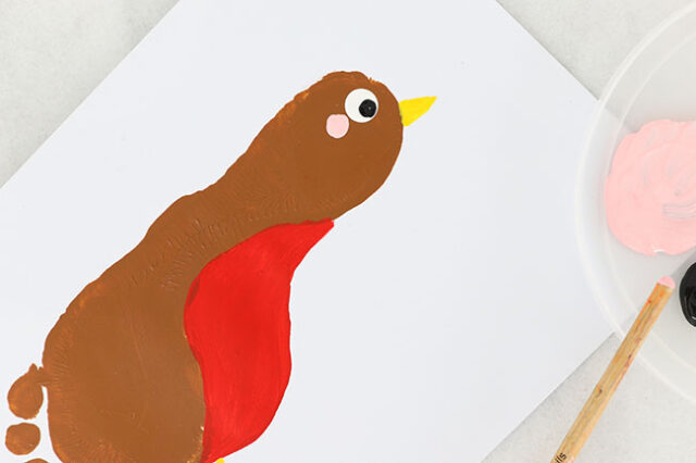 Stamping pink cheek onto robin