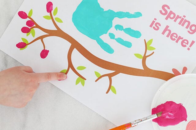 Finger stamping buds onto branch
