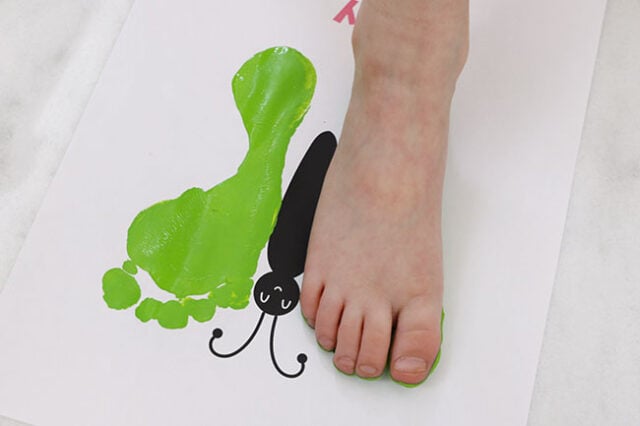 Foot stamping butterfly wings onto paper
