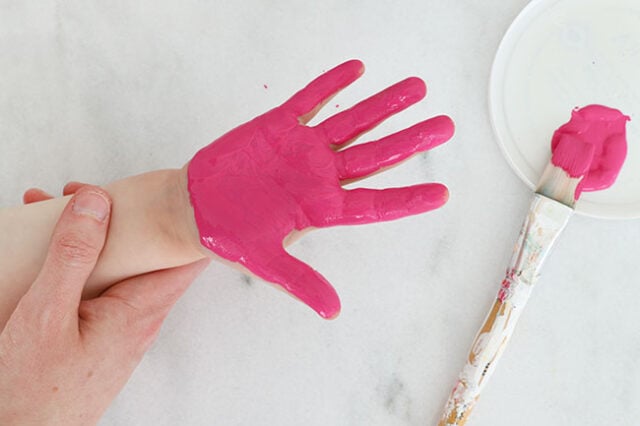 Pink paint applied all over hand
