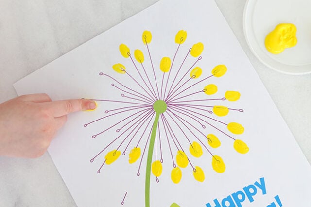 Stamping finger onto dandelion
