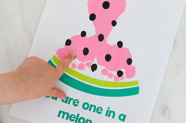 Finger painting seeds on paper