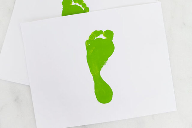 Green footprint on cardstock