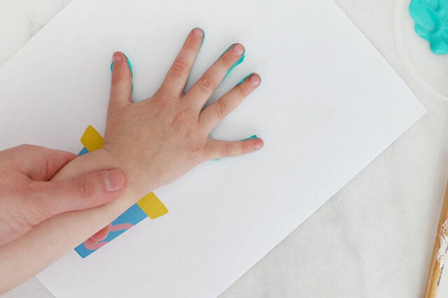 Stamping hand onto paper