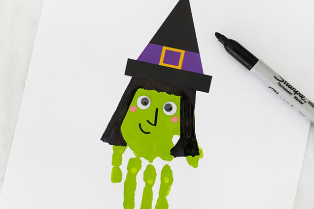 Drawing hair onto witch handprint