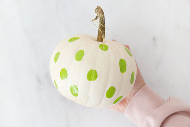 Green witch dots all over pumpkin