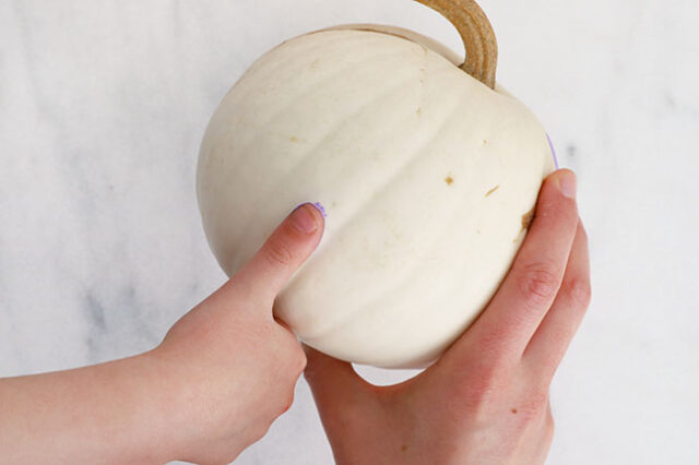 Stamping pastel dots onto pumpkin