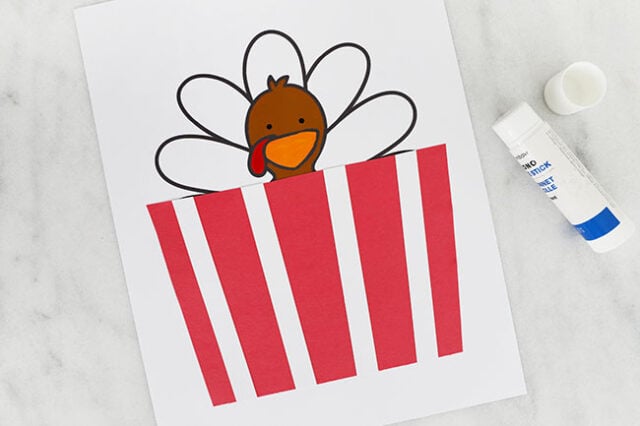 Glue the popcorn bag onto the paper