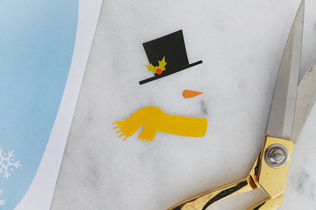 Cutting out snowman paper details