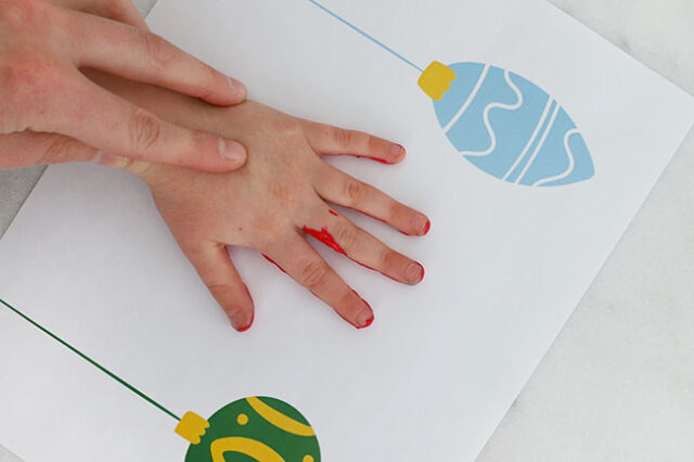 Stamping hand onto ornament page