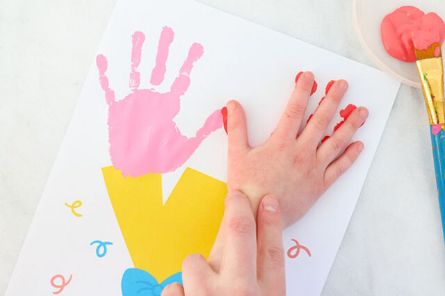 Hand stamping second flower on bouquet paper
