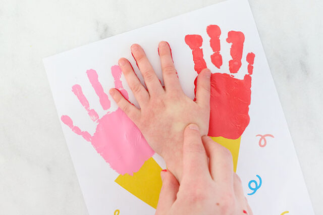 Hand stamping third flower onto bouquet
