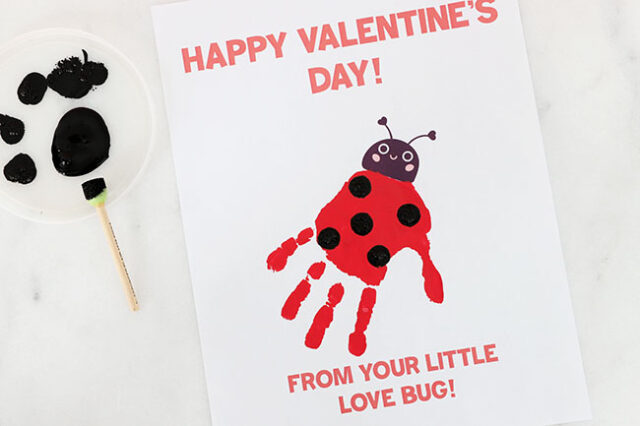 Painting dots onto ladybug handprint