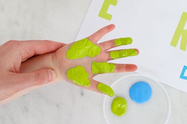 Hand partly painted with green paint