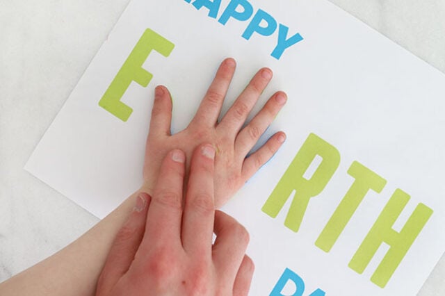 Hand stamping onto Earth Day paper